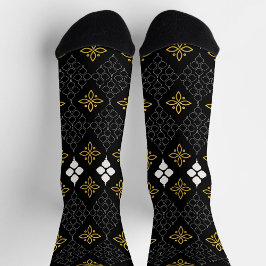 Black socks featuring a gold and white pattern 