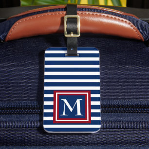 Blått- och vitrandar med den röda monogramen bagagebricka