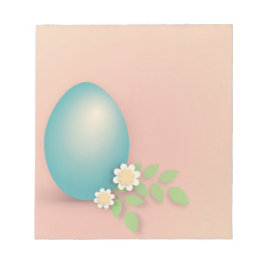 Blått påskägg mellan blommor och löv anteckningsblock