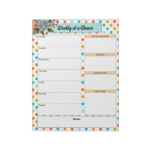 Blommigtens Orange i Blue Polka dots_ Week vid ett Anteckningsblock