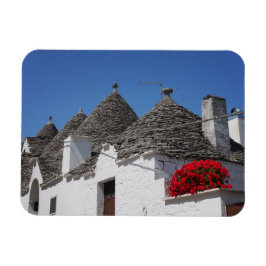 Blommor och trullhus i Geranium i Alberobello Magnet