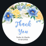 Blue and Yellow Floral Wedding Thank You Runt Klistermärke<br><div class="desc">This beautiful and elegant wedding thank you sticker features watercolor blue,  yellow and white flowers with foliage. The text combines handwritten script and serif fonts for a stylish and modern look. This is perfect for a spring or summer rustic wedding.</div>