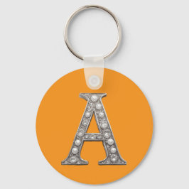Bokstaven A med juveler på gul bakgrund Nyckelring