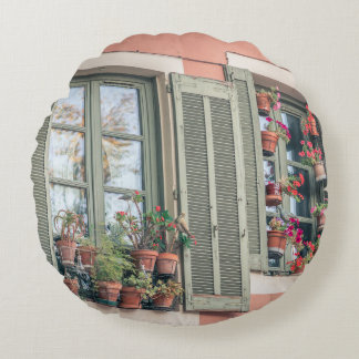 BORTERADE BLOMMOR FÄRG I VAS NÄRA FÖNSTER RUND KUDDE