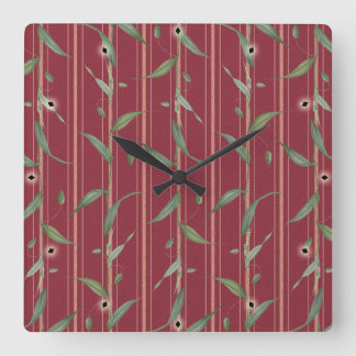 Branch of leaves on red wallpaper fyrkantig klocka