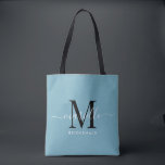 Bridesmaid Gift White Black Monogram Dusty Blue Tygkasse<br><div class="desc">Den här Bridesmaid tote-väskan har ett handskrivet typografiskt monogram med vita och svarta skript med dekorationer på en dammig blå bakgrund. Presentera dina brudtärnor med en tärning för att bära artiklar på bröllop-dagen och presenteras traditionellt vid repetitionsmiddagen eller före.</div>