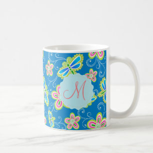 Brillant blommar, sländor och virvlar runt på kaffemugg