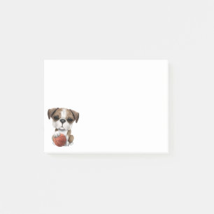 Brittisk bulldoggvalp som leker med basket post-it block