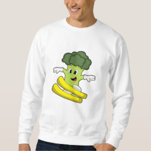 Broccoli som skidåkare med skidor lång ärmad tröja