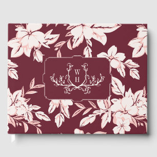 Bröllop med rosaburgunderblommor och monogram gästböcker
