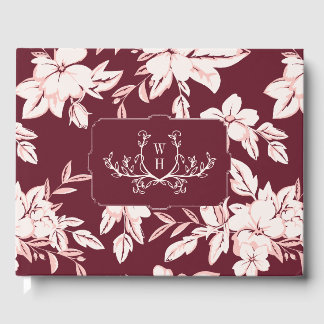 Bröllop med rosaburgunderblommor och monogram gästböcker