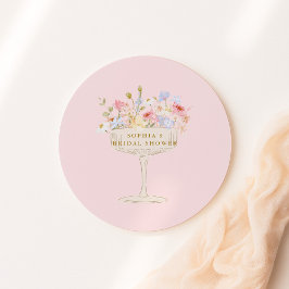 Bröllopsfest med rosa champagne och vilda blommor runt klistermärke