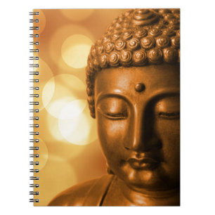 Bronze Buddha Statue med Golden Bokeh Background Anteckningsbok
