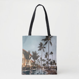 Brown wooden lounge chairs near pool surrounded by tygkasse