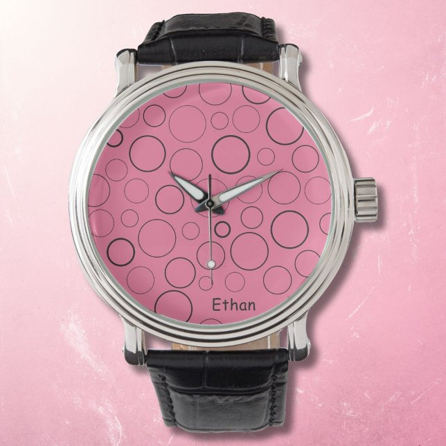 Bubblor och ringar, svarta cirklar på rosa armbandsur (Skapare uppladdad)