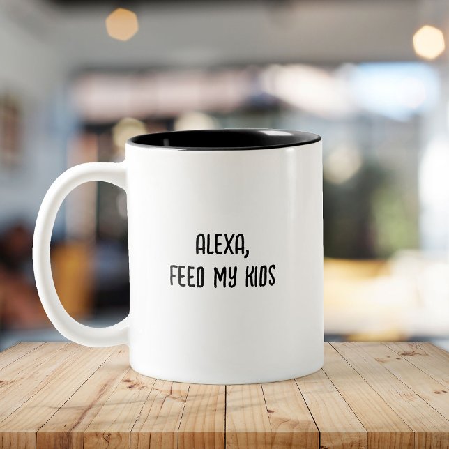 Busy Parent Funny Tired Mamma Mors dag Två-Tonad Mugg (White mug on a wooden table with black interior and text reading "Alexa, feed my kids." )