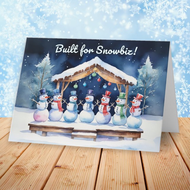 Byggt för Snowbiz Funny Snögubbars jul Helgkort (A funny Christmas card with picture of snowmen on a wooden stage, with humorous caption)
