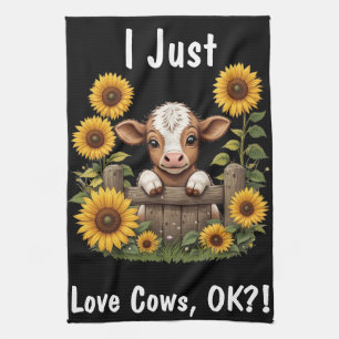 Calf söker över stängsel omgiven av solblommor kökshandduk