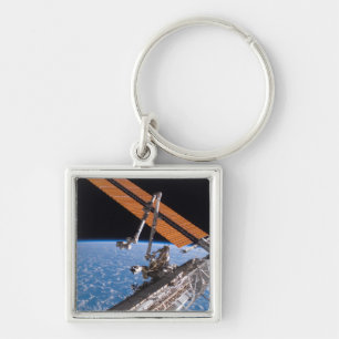 Canadarm2en och den sol- samlingpanelvingar fyrkantig silverfärgad nyckelring