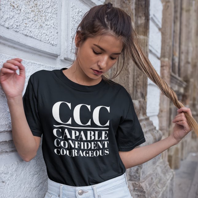 CCC-kapacitet, säker, modig T Shirt (Young woman wears a "CCC:Capable, Confident, Courageous" black t-shirt.)