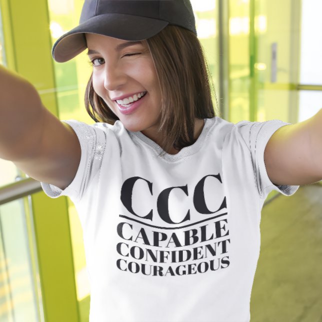 CCC-kapacitet, säker, modig T Shirt (Young woman wears a "CCC:Capable, Confident, Courageous" white t-shirt.)