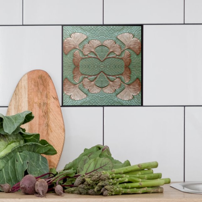 Ceramic Gingko Tile Kakelplatta (Single Green and copper Gingko leaf tile shown with white tiles in a kitchen.)