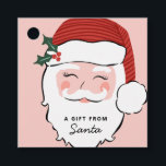 Cheerful Santa Ansikte | Rosa och Röda | Från tomt Gåvor Etiketter<br><div class="desc">Den här presentens märkre är perfekt för gåva från Jultomten och har en glad jultomte ansikte på en rosa bakgrund med texten "en gåva från tomten" i svart brev på tomtens vita skägg. Baksidan har rosa och rött diagonalt rand.</div>