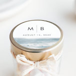 Coastal Blue Watercolor Monogram Wedding Favor Runt Klistermärke<br><div class="desc">Seal your wedding favors with this round sticker from the Low Tide collection by Navy Road Creative. Featuring a minimalist monogram,  your wedding date,  and soft watercolor ocean artwork in misty blue,  it’s a perfect finishing touch for beach or destination celebrations.</div>