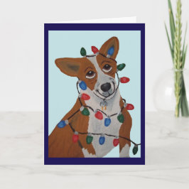 Corgi intrasslad i julgransbelysning kort