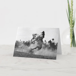 Cowboy på en buckande bronco kort