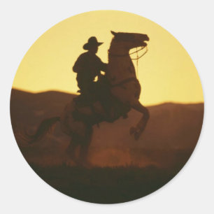 Cowboyen på Rearing Horse Runt Klistermärke