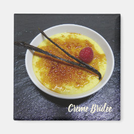Creme brulee on slate with raspberry and vanilla magnet