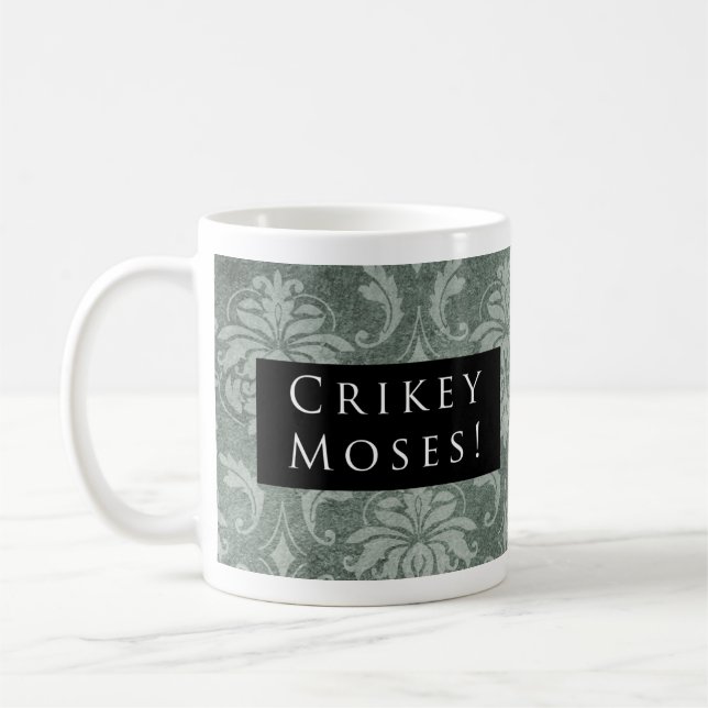 Crikey Moses! Mönstersvart Kaffemugg (Vänster)