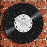 Custom Vinyl Record Vintage Monogram Clock Stor Klocka<br><div class="desc">Bring the golden era of music into your home with this sleek, customizable vinyl record wall clock. Designed with a high-fidelity aesthetic, this clock features a realistic record groove image and a personalized center label. It is customizable: Change the background color of the record label and the clock numbers to...</div>