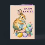 Cute Bunny Painting Easter Eggs Greeting Card Helgkort<br><div class="desc">This charming Easter card features an adorable vintage-style bunny perched on a stool carefully painting colorful Easter eggs with tiny paint jars by its side. The soft peach background and whimsical illustration give this card a nostalgic storybook feel that's impossible not to love. It's the perfect card to send to...</div>