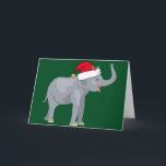 Cute Elephant-julen i Santa Hat-Helgdag Card Helgkort<br><div class="desc">Cute helgdag djur är min favoritdel av julen. En vacker grått-elefant som bär en röd julhatt och tittar lycklig på en festlig grönt bakgrund. Det fyller mig med julandan.</div>