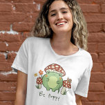 Cute Frog och svampar får vara hovmossar Tecknad T Shirt<br><div class="desc">Den här söta T-shirt-skjortan har en handdragen kawaii stil-tecknad groda med svamphatt, tillsammans med andra svampar, snigel, blomma, fjäril och gräs. Ett färg-schema med rött, kalk, grönt, brun, orange, gult och persika är perfekt för antingen Indie eller Cottage Core Aesthetic älskare. Anpassa texten, om du vill, till en personlig namn...</div>