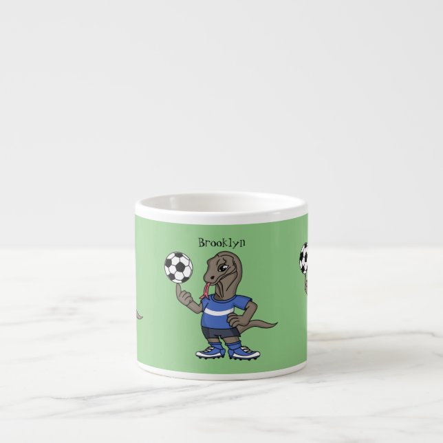Cute funny Komodo dragon playing soccer cartoon Espressomugg (Framsidan)