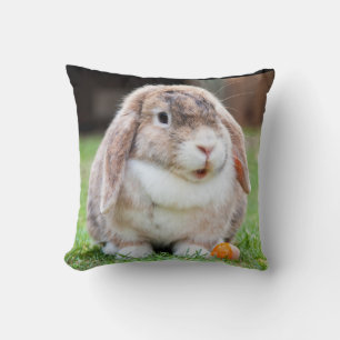 Cute Lop Eared Rabbit in Grass with Carrot Kudde