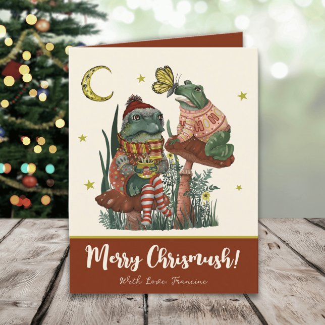 Cute Red Mushroom Frog and Toad God jul Helgkort (Whimsical Merry Christmas card with an illustration of frogs sitting on mushrooms drinking cocoa)