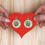 Cute Smiling Skeletons Santa Hats Ornaments White Örhängen<br><div class="desc">Öronringarna har ett sött leende skelett som håller rött och prydnadsföremål av grönt fram till ögon och bär en röd julhatt som pendlar ut från en abstrakt ljusröd och grönt stänk form på en vit bakgrund med cirklar.</div>