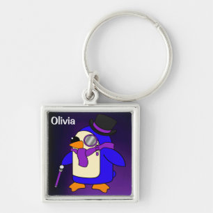 Cute tecknad penguin vid djup lila violett fyrkantig silverfärgad nyckelring