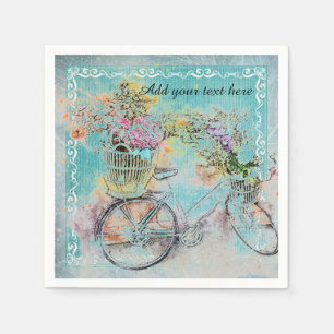 Cykel med blommabasket på blåttburlap pappersservett