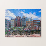 Cykelhus vid Amsterdams kanal Nederländerna Pussel<br><div class="desc">Den här fantastiska staden med pussel i pusslet har cyklar längs kanalen i Amsterdam med byggnad i bakgrunden. #amsterdam #jigsawpuzzle #gift #stockingstuffers</div>
