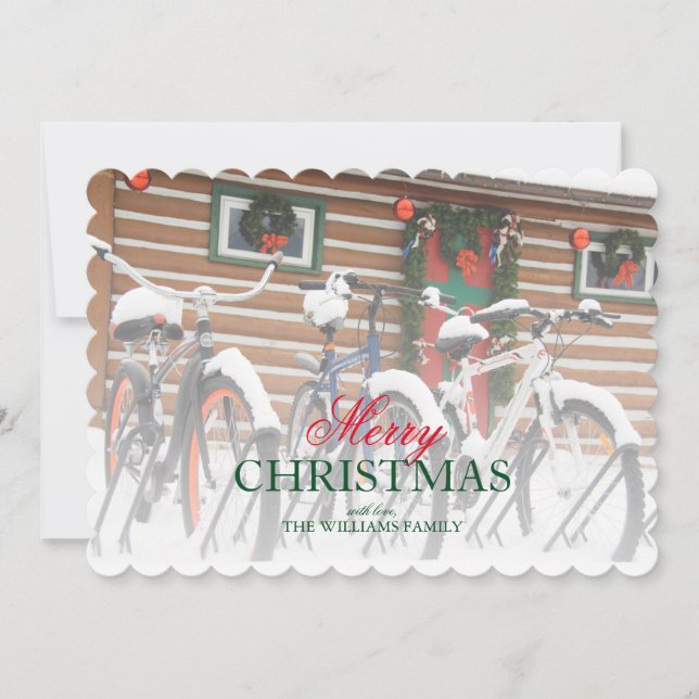 Cyklar med snötäcke nära festlig stuga julkort (Framsida)