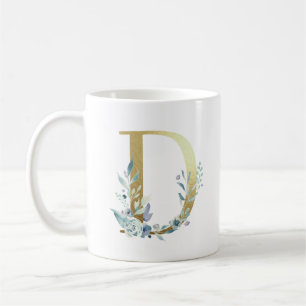 D guld initial med blå blommigt löv kaffemugg