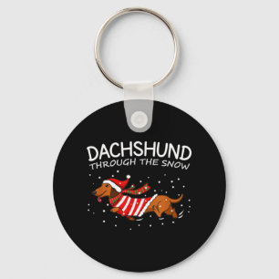 Dachshund genom Snö Rolig hund jul Nyckelring