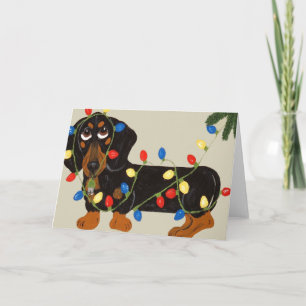 Dachshund intrasslad i julgransbelysning svart/ lj helgkort