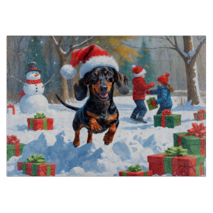 Dachshund springer i snö med julhatt