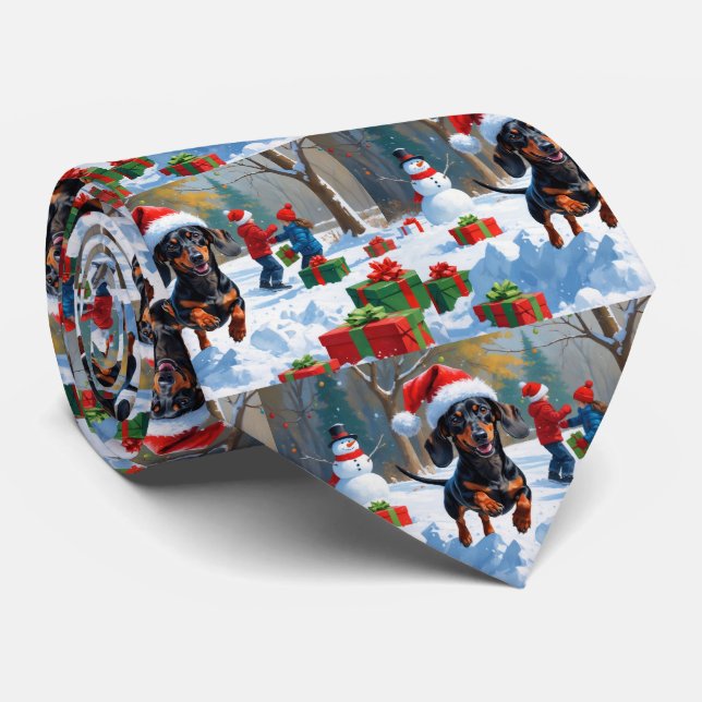 Dachshund springer i snö med julhatt slips (Rullad)